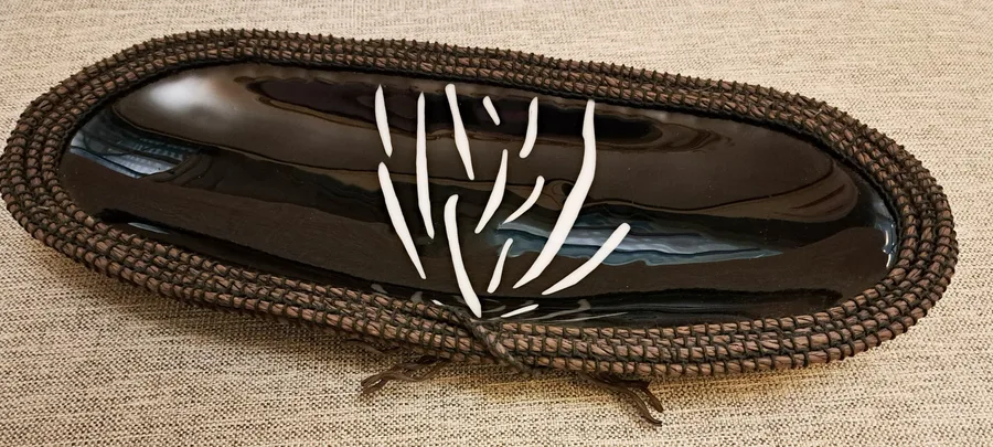 Wooven Coolamon, a glass and woven grass work by Cherie Platen